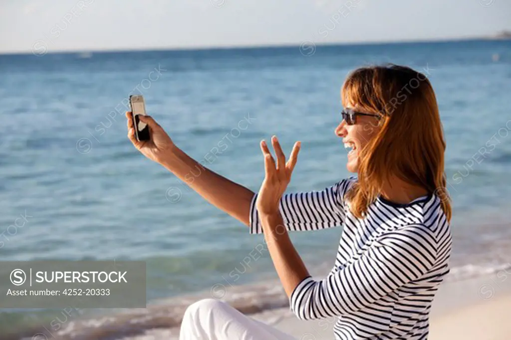 Woman videophony beach