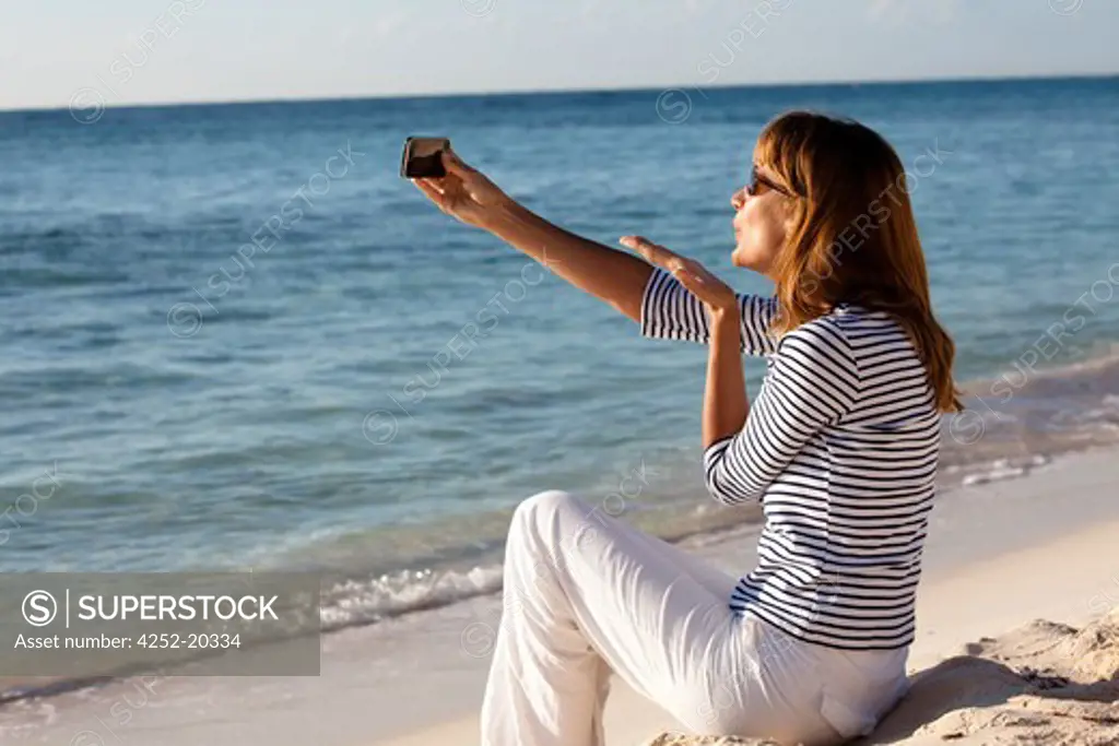Woman videophony beach
