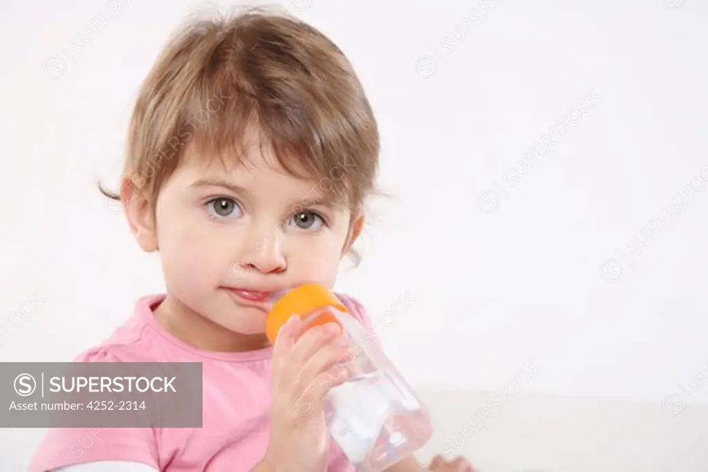 Little girl feeding bottle