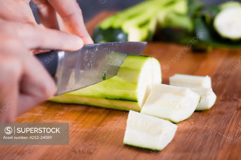 Woman cut zucchinis