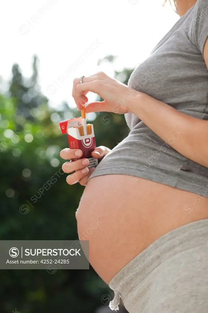 Pregnant woman smoking tobacco