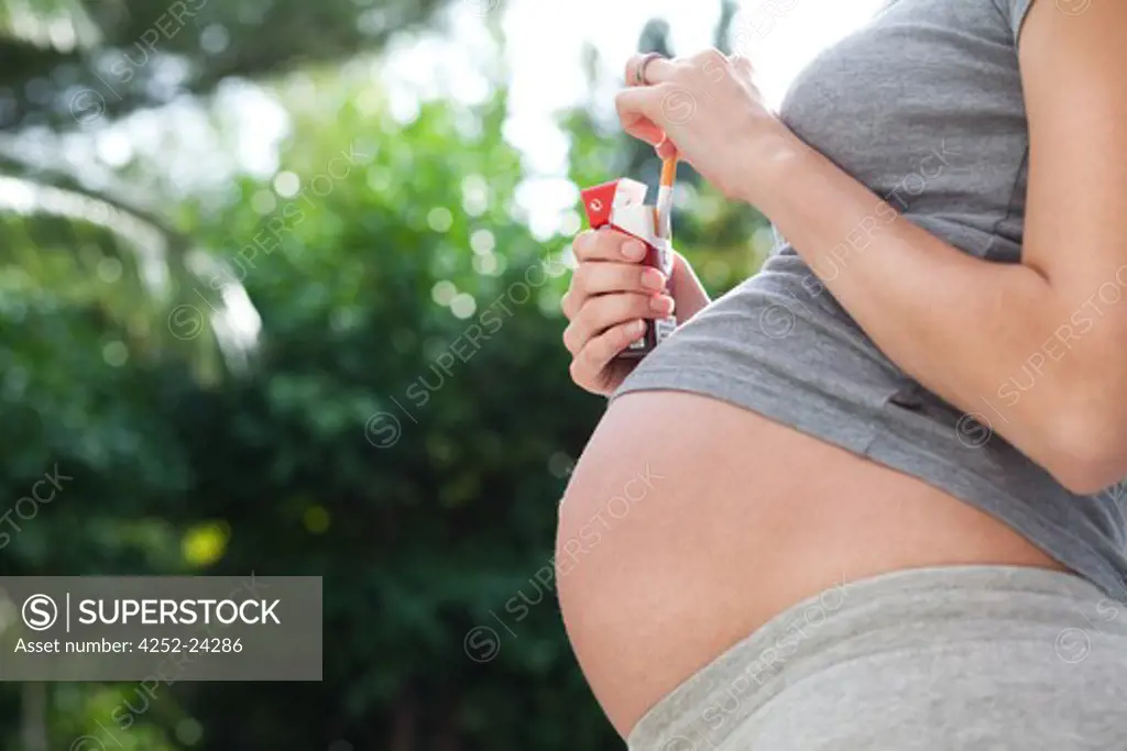 Pregnant woman smoking tobacco