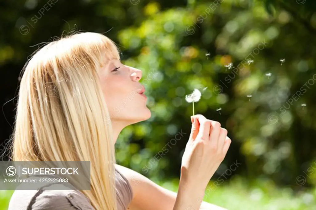 Woman dandelion blow