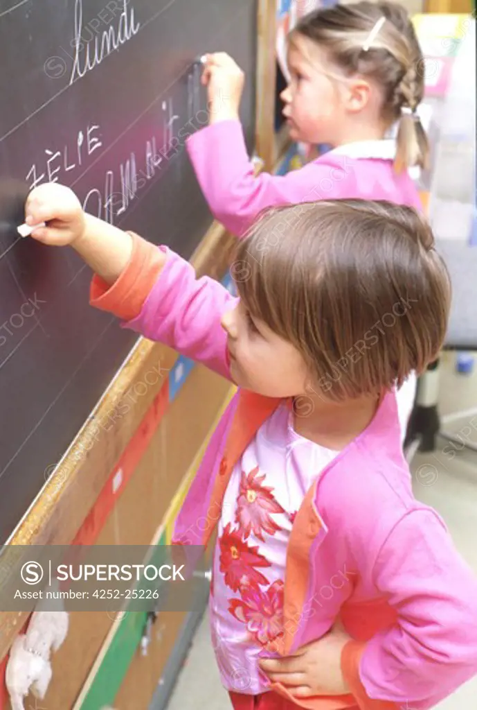 children inside girl school writing blackboard chalk class