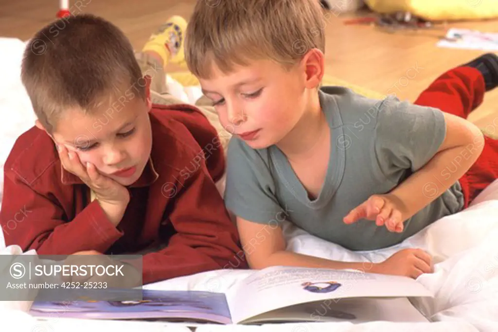 children inside boy reading book