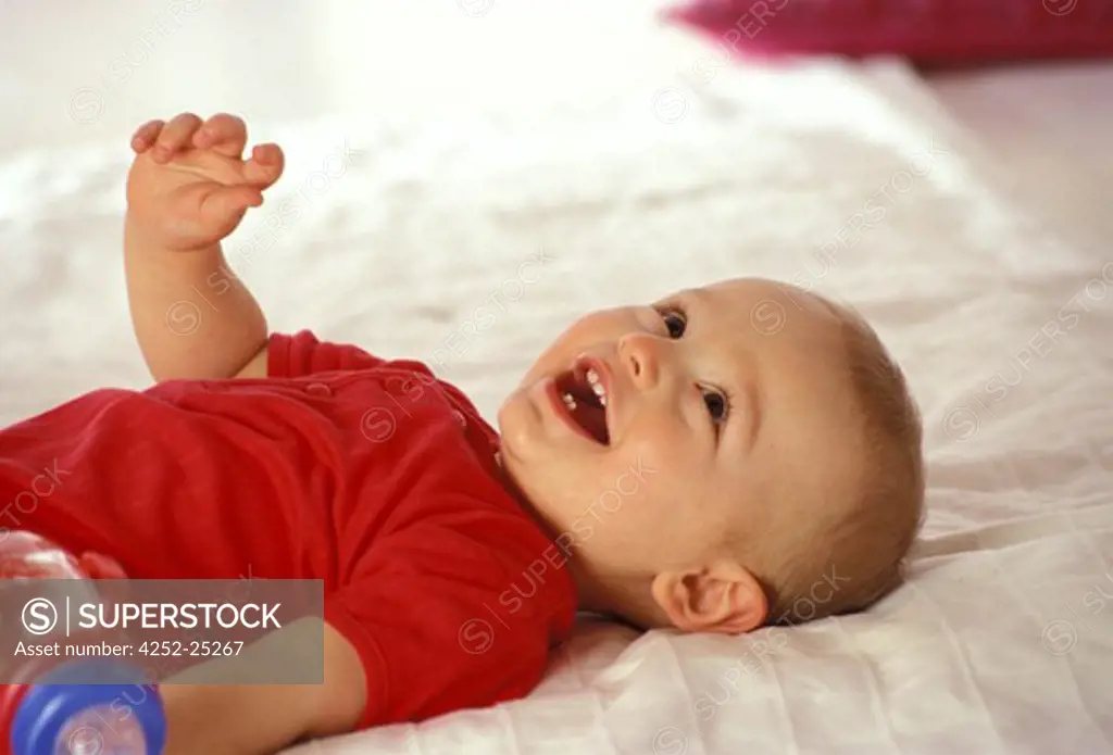 children inside boy baby bed baby's bottle laughing teeth