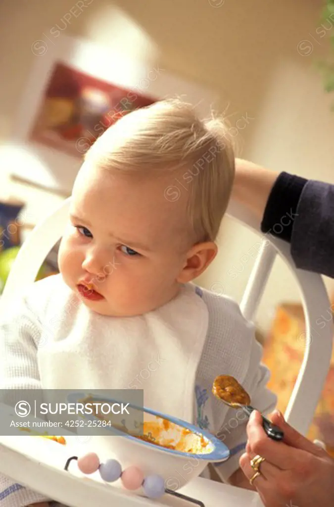 family inside woman baby child food chair spoon soup sulking mother