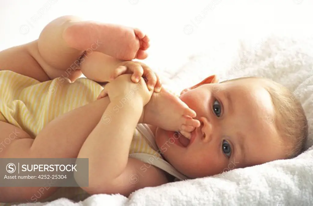 children inside portrait baby expression biting foot