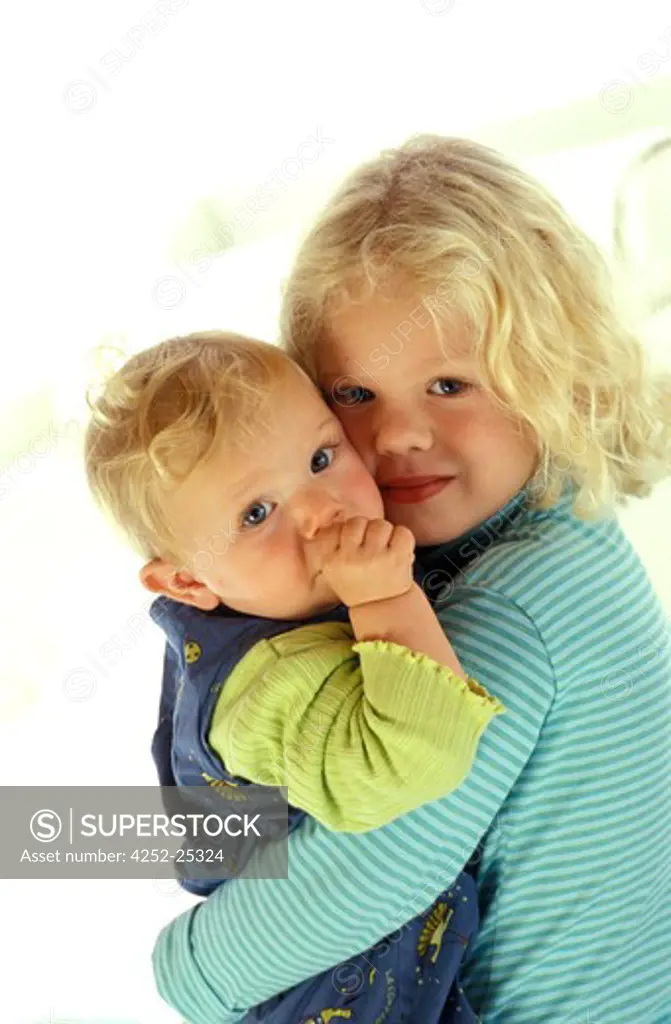 children inside girl portrait baby sister brother carrying tenderness sucking thumb