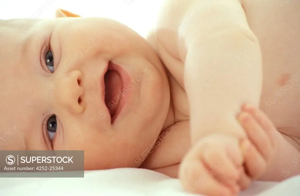 children inside boy portrait baby expression nude lie down bed laughing