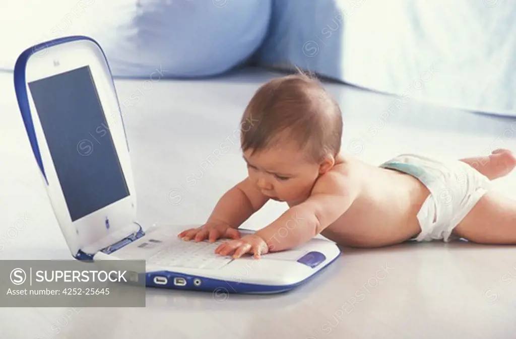 children inside play computer baby expression nappy lying down look discover questioning enjoy happiness