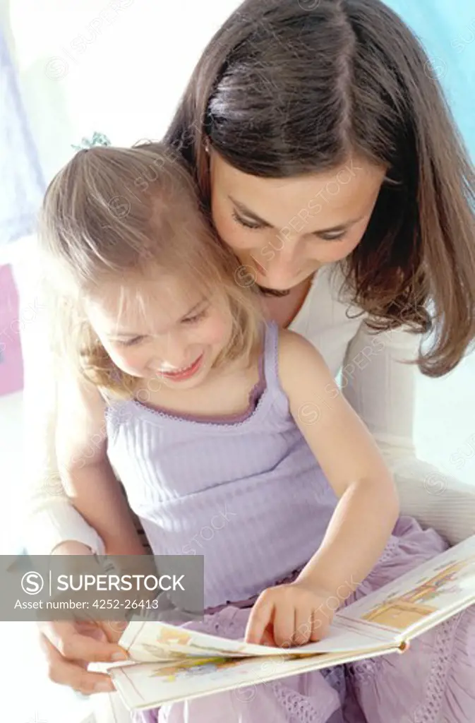 Woman and little girl looking at book