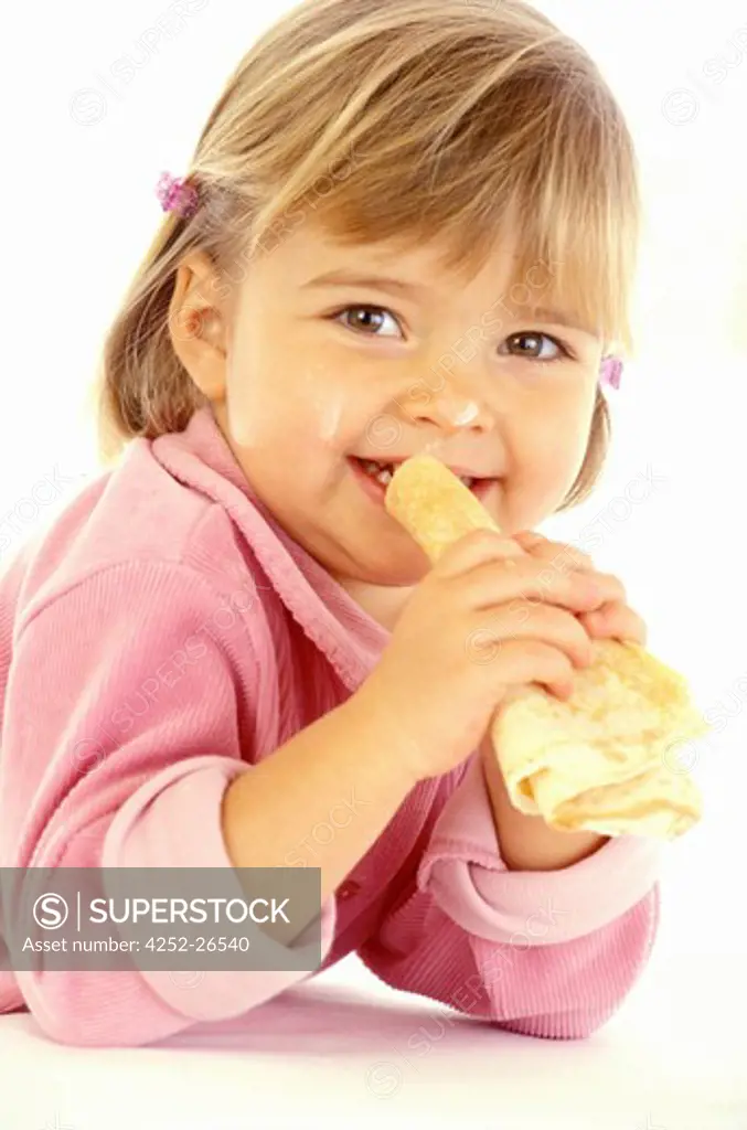 Little girl eating a pancake