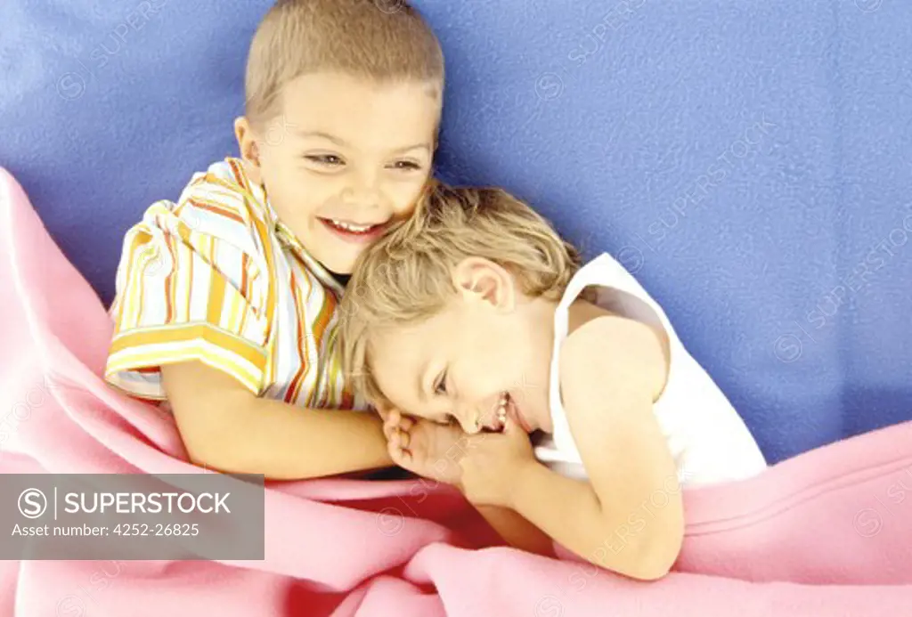 Children lying in a bed
