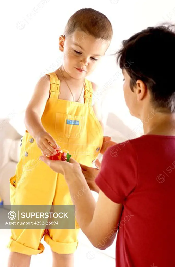Mother giving candies to her child