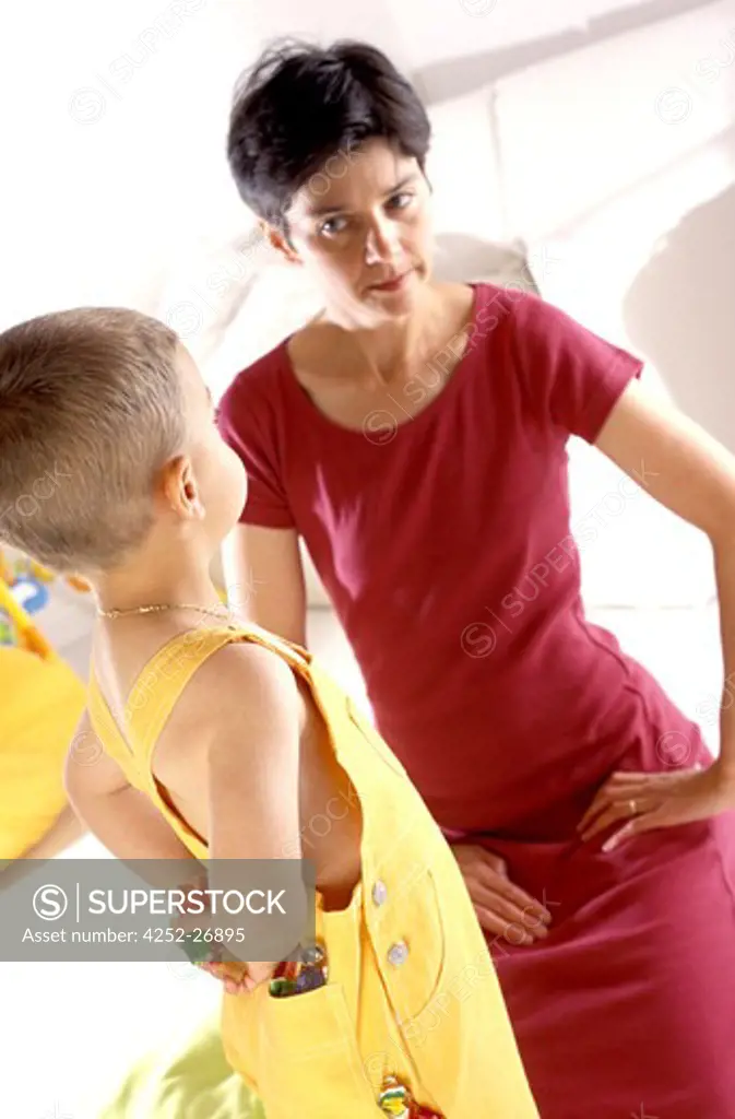 Woman scolding a child who stole candies