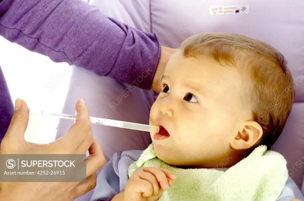 Woman giving medicine to baby