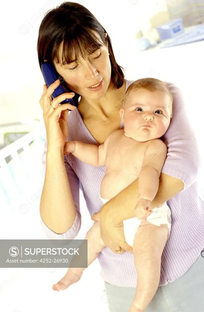 Woman with baby making phone call