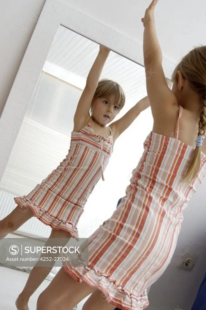 Child dancing in front of a mirror