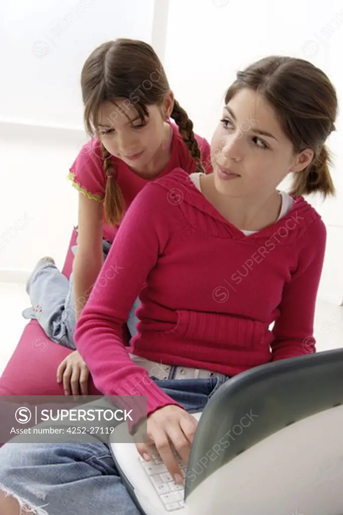 Sisters with a computer