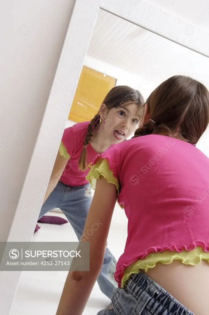 Little girl in front of a mirror