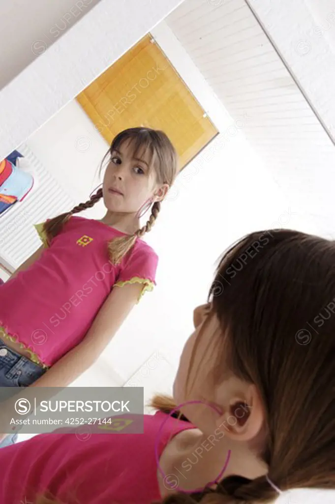 Little girl in front of a mirror