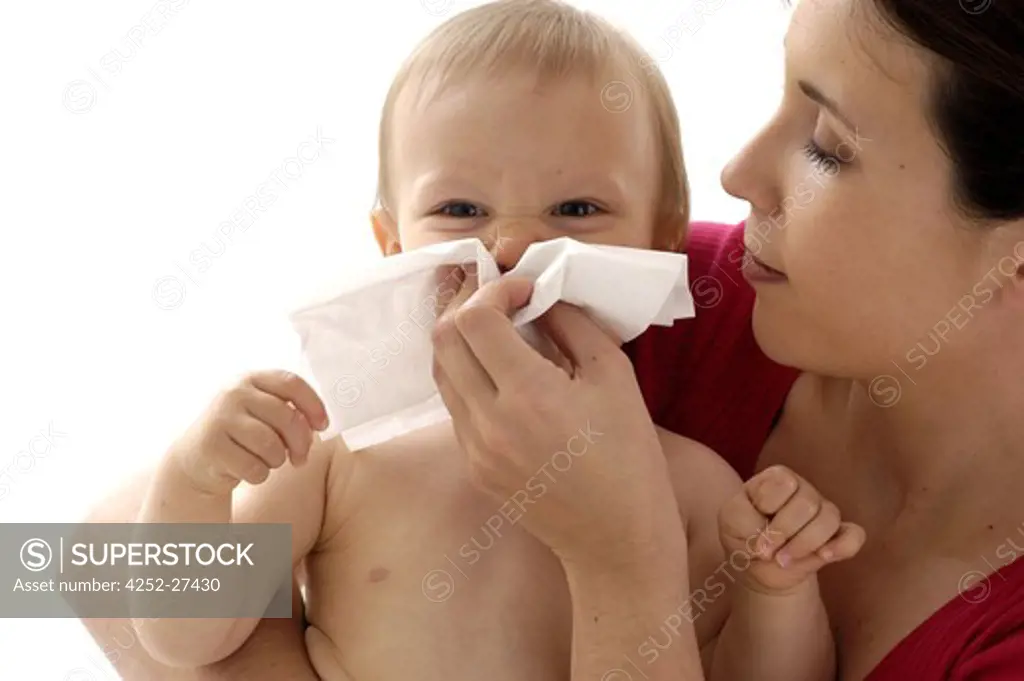 Woman blowing baby's nose