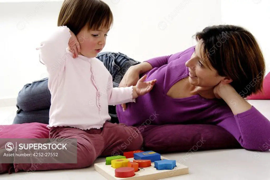 Woman and child girl playing
