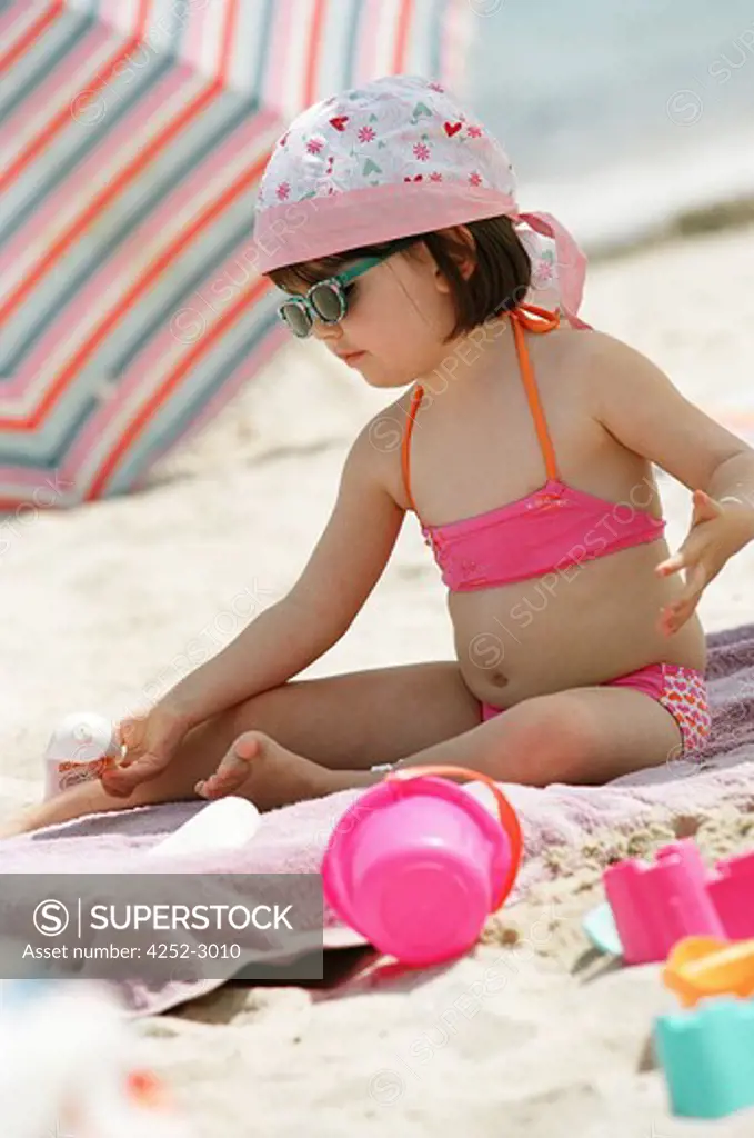 Little girl with sun cream
