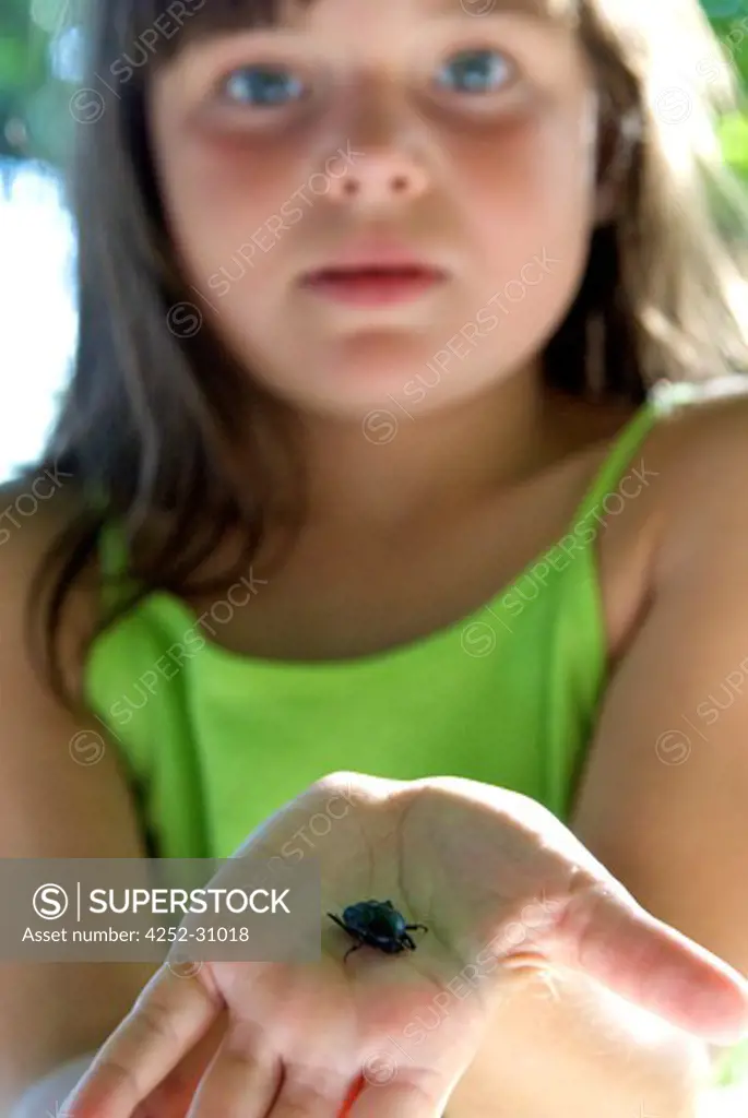 Little girl beetle hand