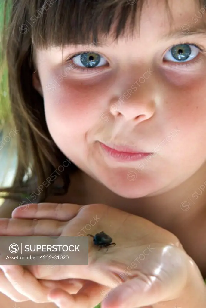 Little girl beetle hand