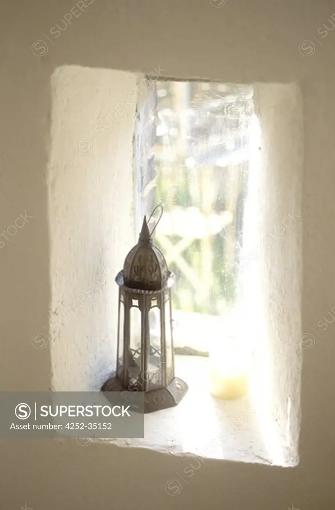 Oriental lantern on a small wall window