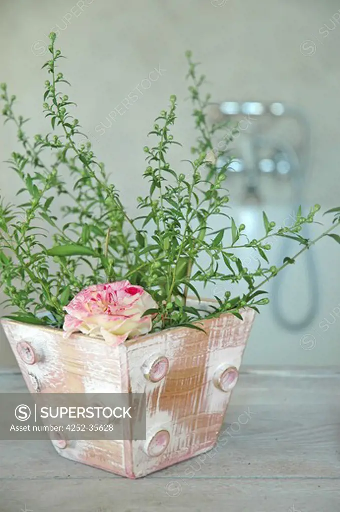 Flower arrangement into a patina painted pot