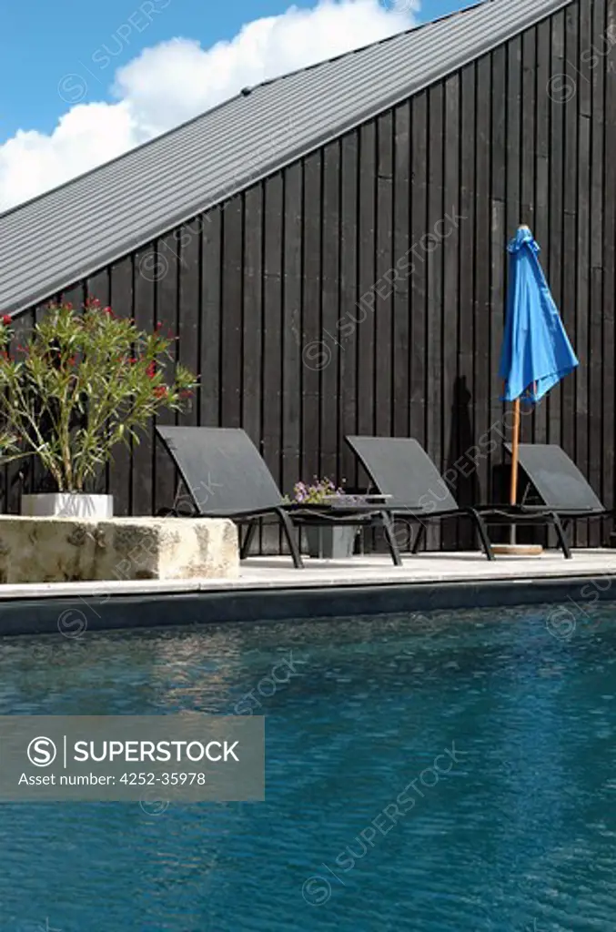 Swimming pool with deckchairs