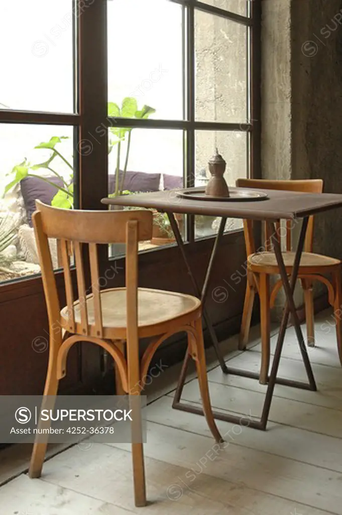 'Bistrot' style table and chairs in front of a window