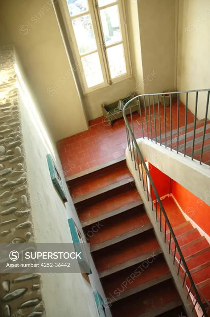 View from above of red stairs with raw walls