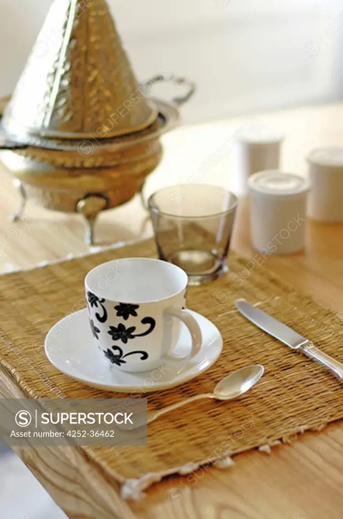 Table set for breakfast with wicker table mats