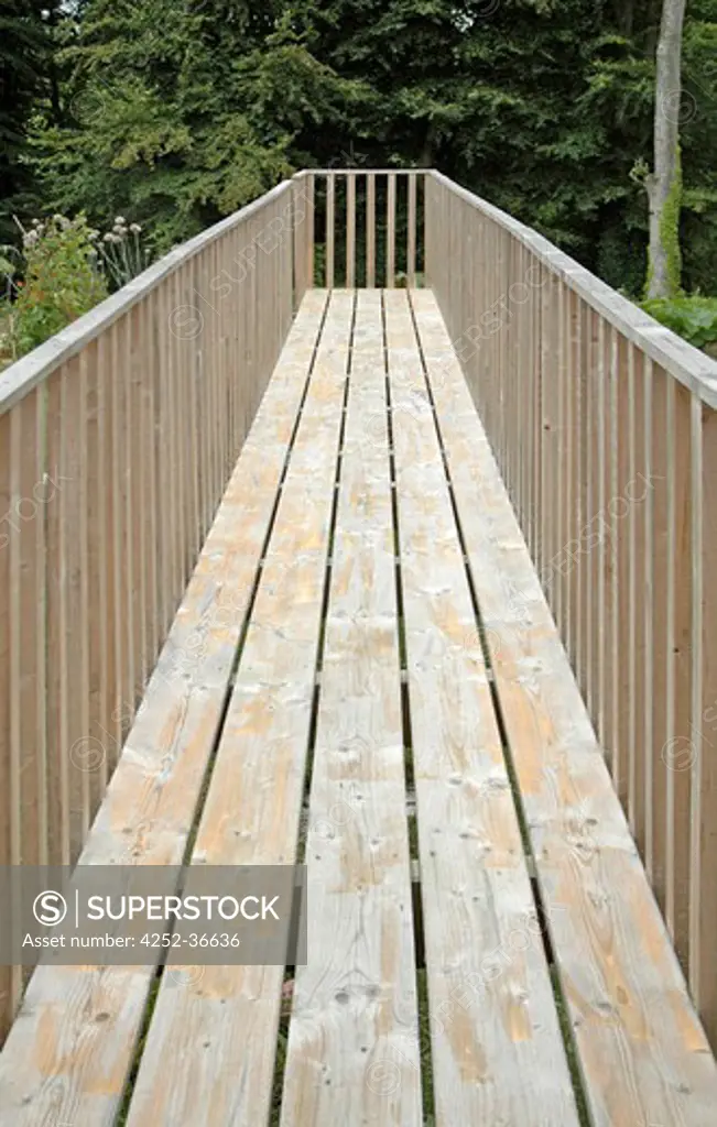 Wooden footbridge accross a garden