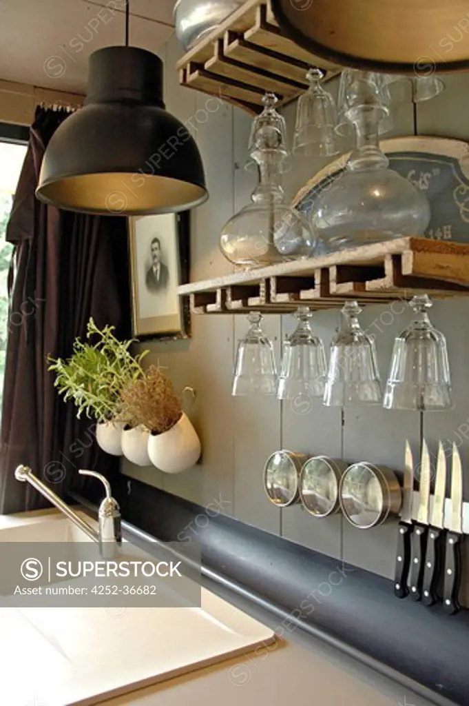 Kitchen sink with wooden shelves on the wall