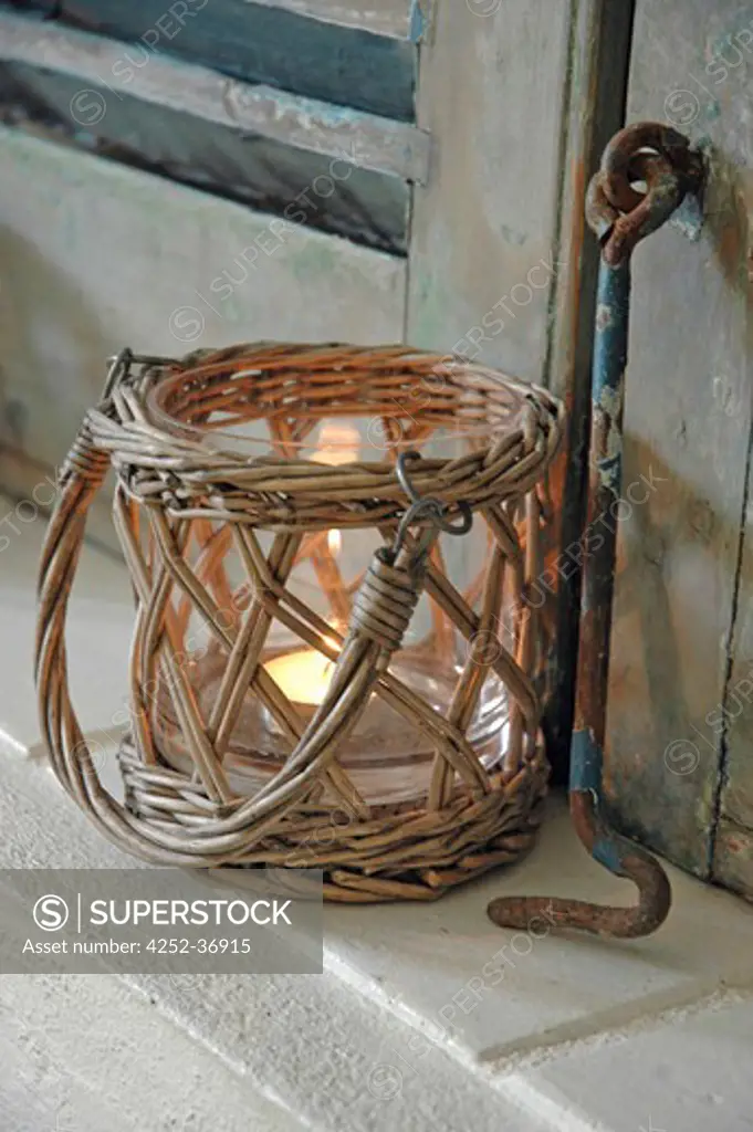 Wicker and glass candle jar