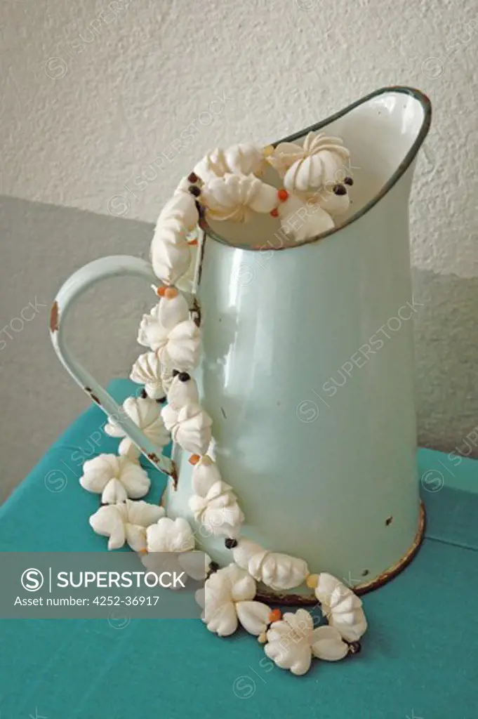 Shell necklace into an old pitcher