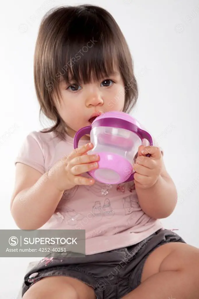 Little girl feeding bottle