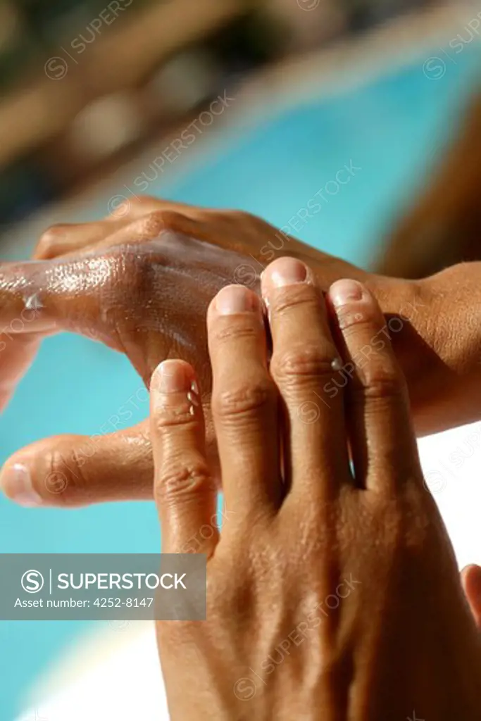 Woman sunscreen cream and hands