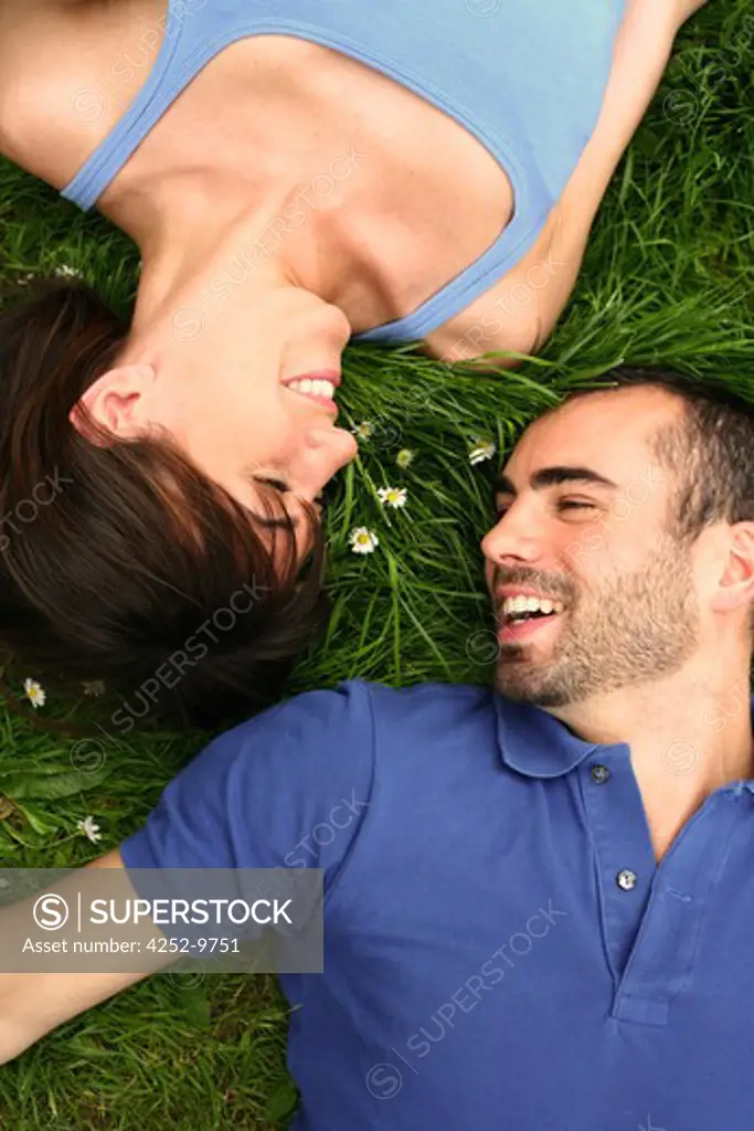 Couple lying down grass