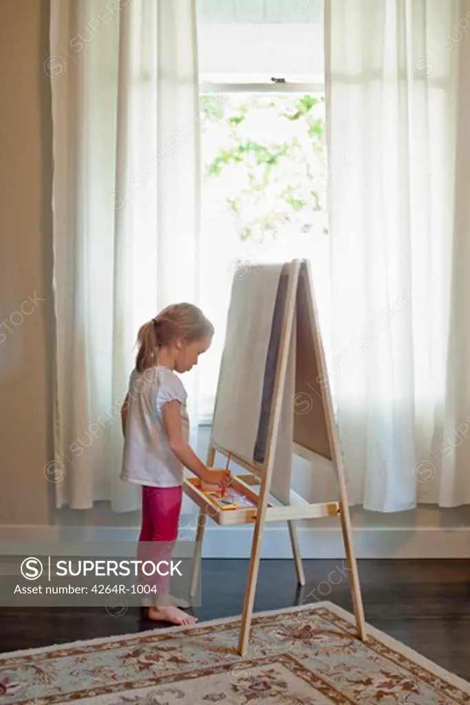 Girl painting on easel