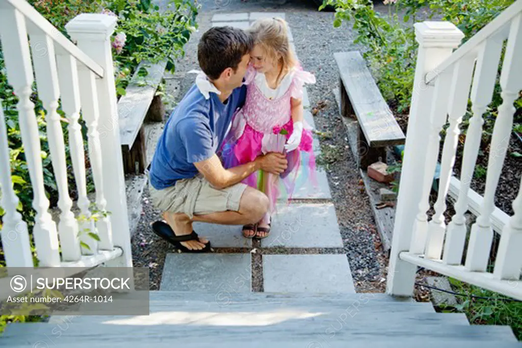 Dad talking to daughter by porch