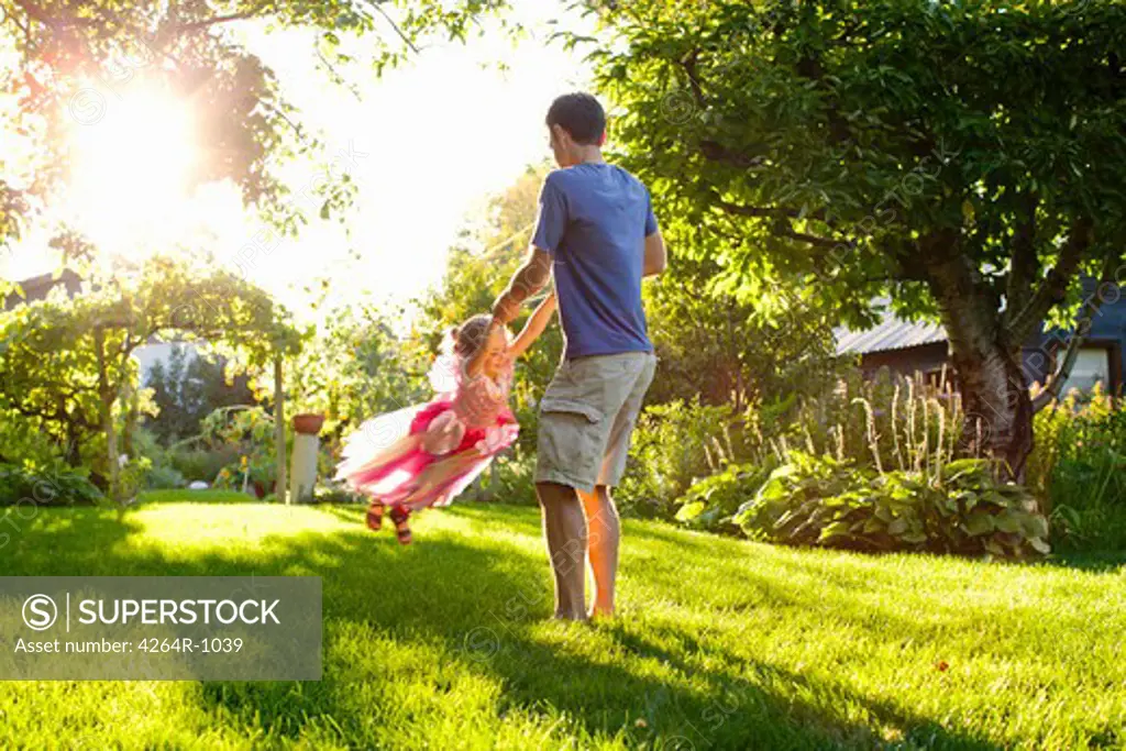 Dad and daughter playing in garden