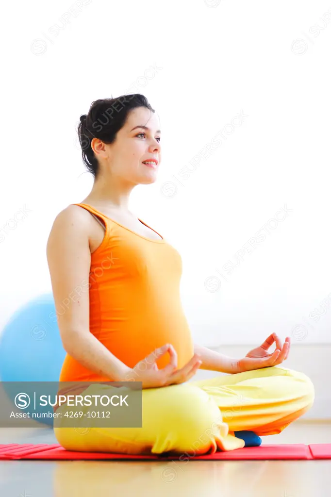 Pregnant woman practising yoga.