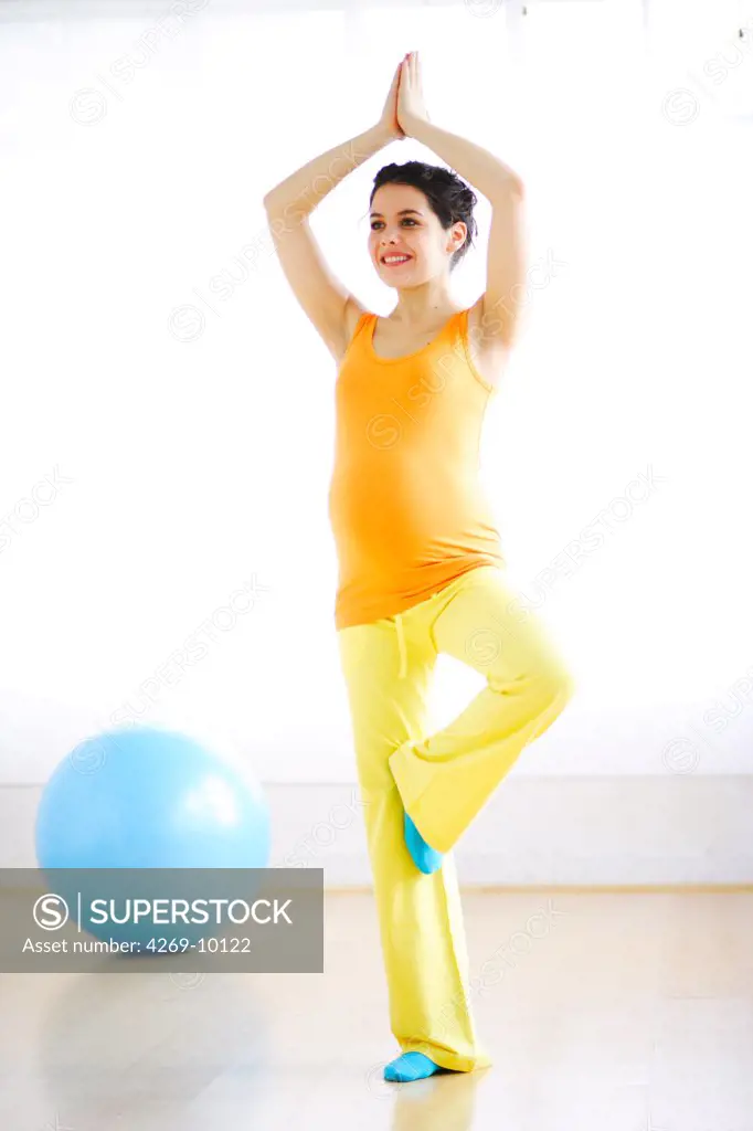 Pregnant woman practising yoga.