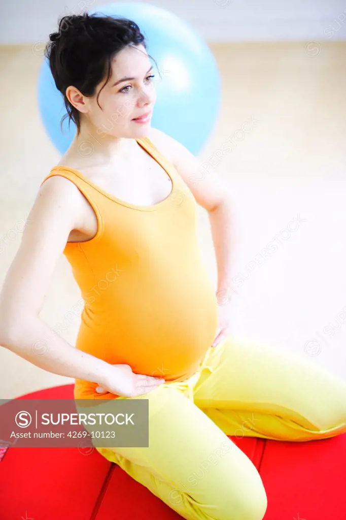 Pregnant woman practising yoga.